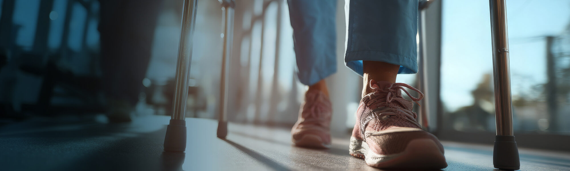 Person in sneakers walking with walker